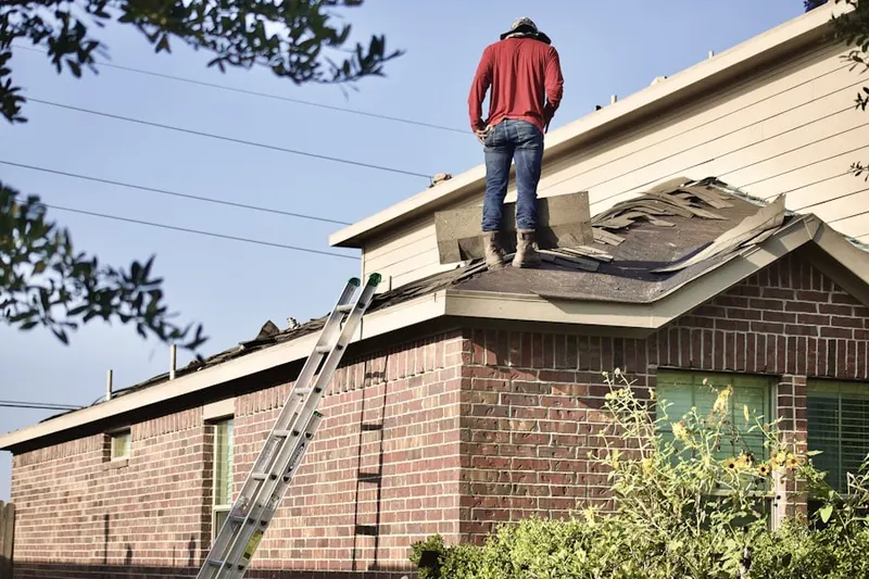 Professional roofer working on a residential roof in Blue Rock Manor
